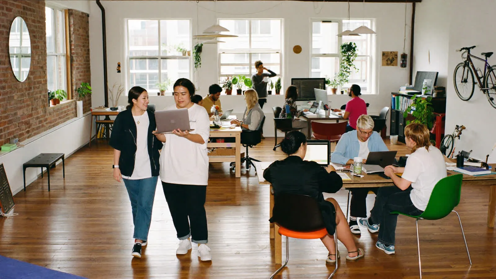 A founding team at work in a bright brick loft